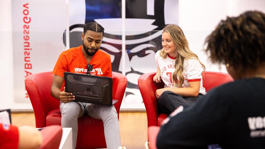 Students sitting in the Kimbrough Lobby looking at a laptop